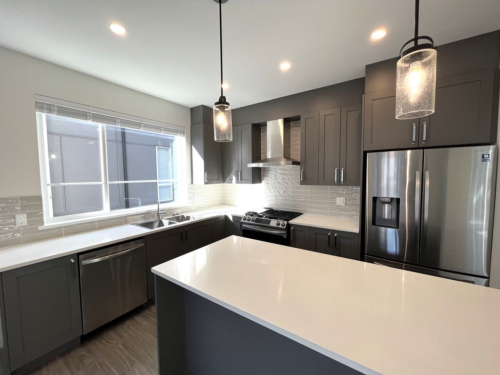 a kitchen with stainless steel appliances and a white counter top