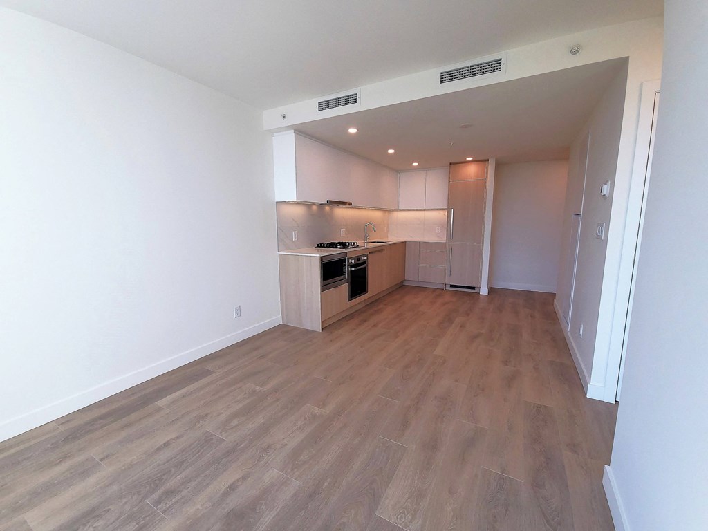 an empty living room and kitchen in a new apartment