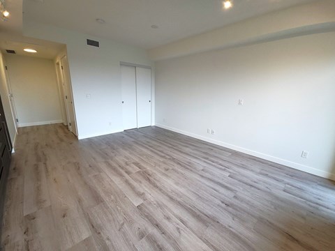 A room with a wooden floor and white walls.