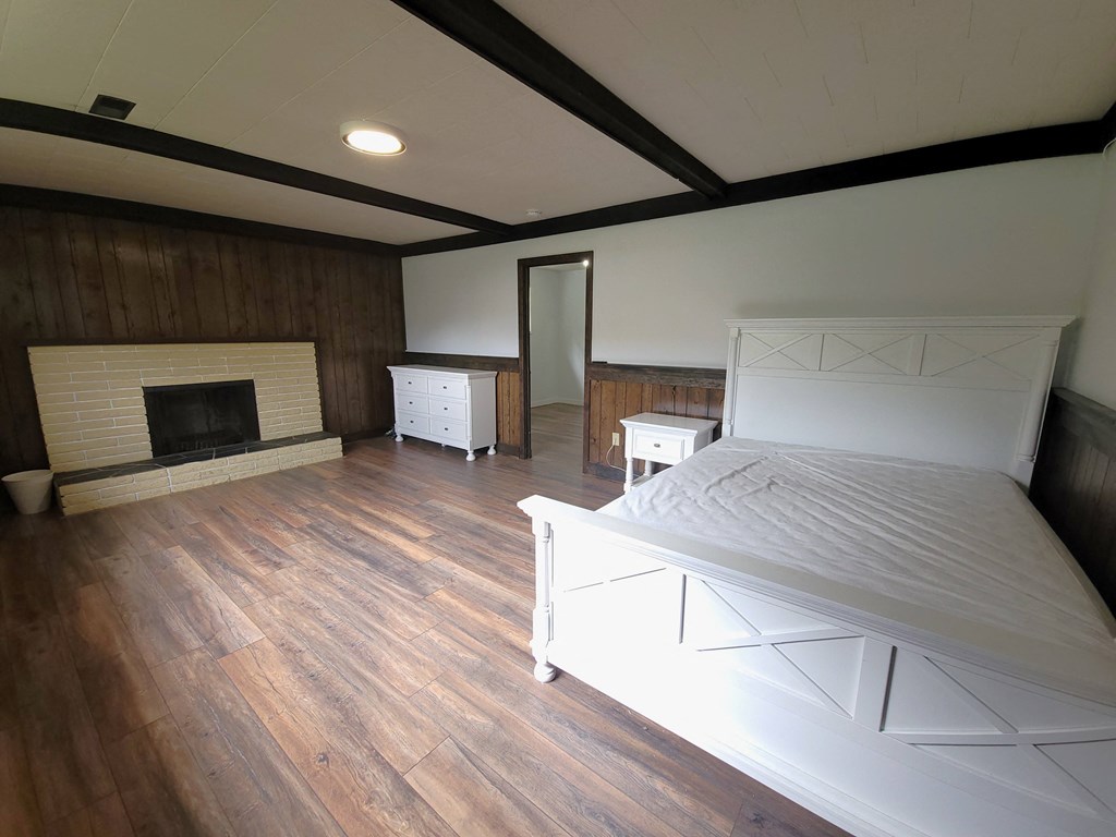 a bedroom with a bed and a fireplace