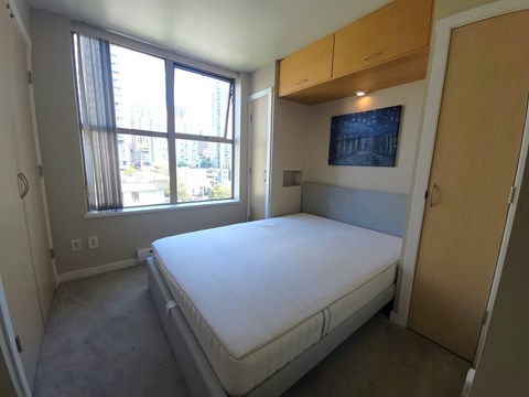 a bedroom with a bed and a window