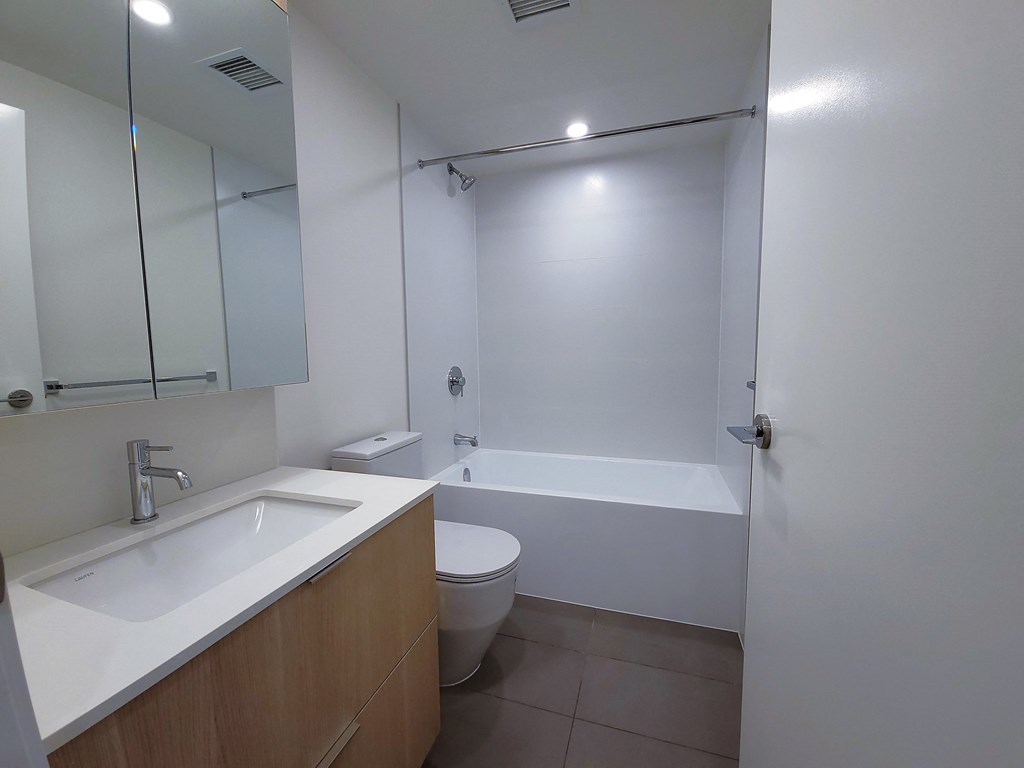 a bathroom with a sink toilet and a bath tub