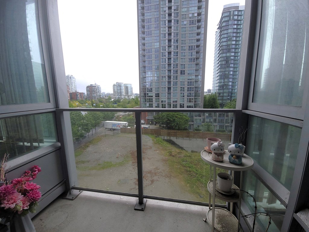 a room with a balcony and a view of the city