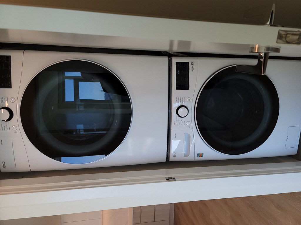 two microwaves on top of each other on a shelf