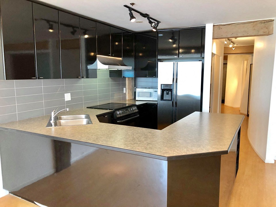a kitchen with a counter top and a refrigerator