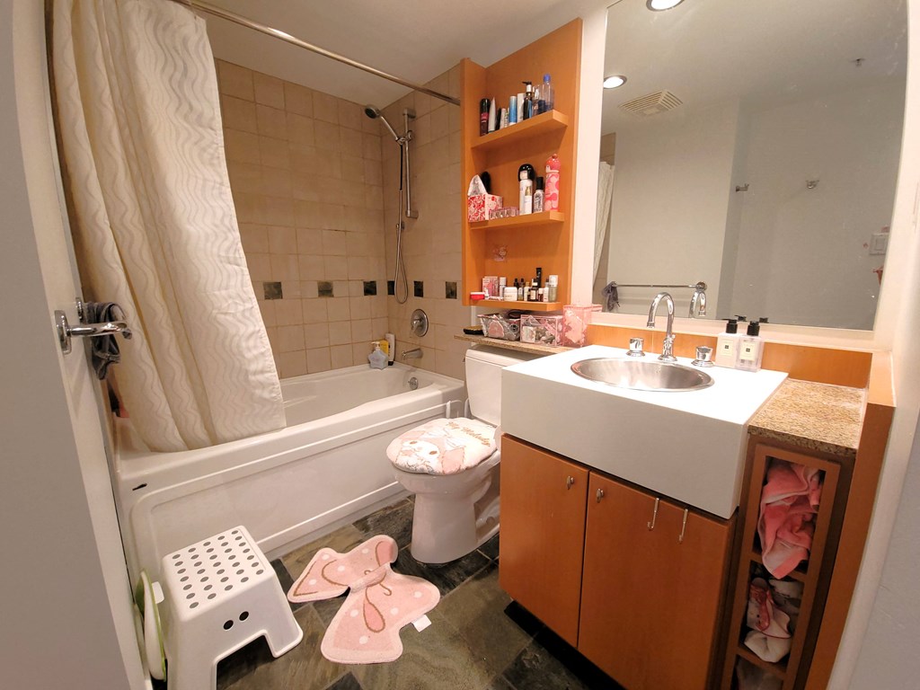 a small bathroom with a sink toilet and bath tub