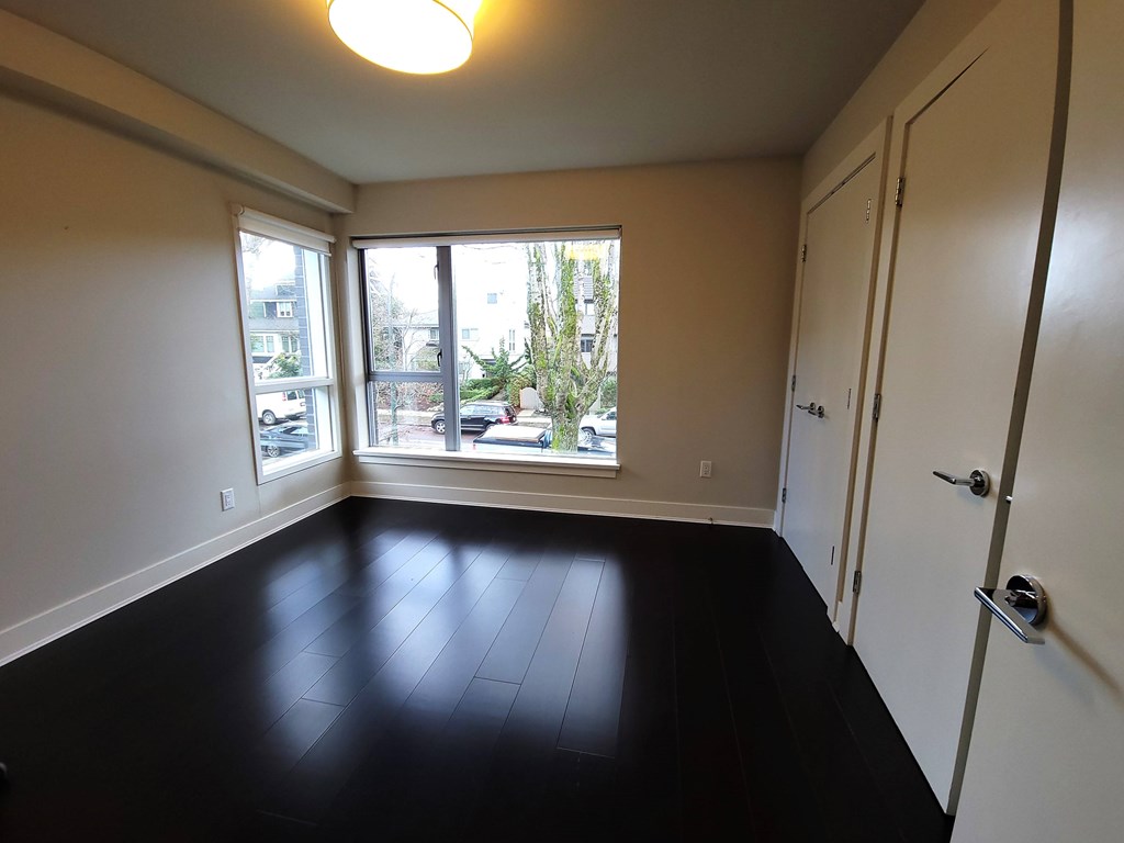 A room with a black floor and white walls.