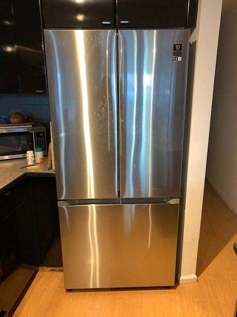 a stainless steel refrigerator in a kitchen