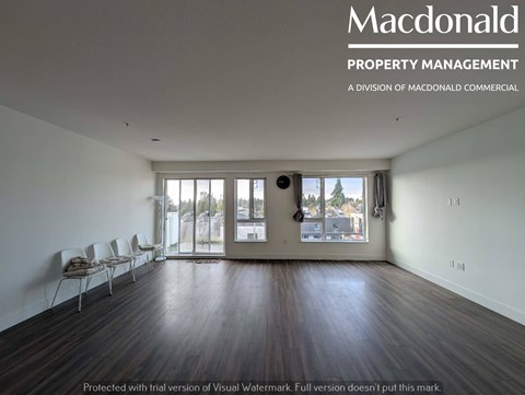A room with a MacDonald Property Management logo on the wall.
