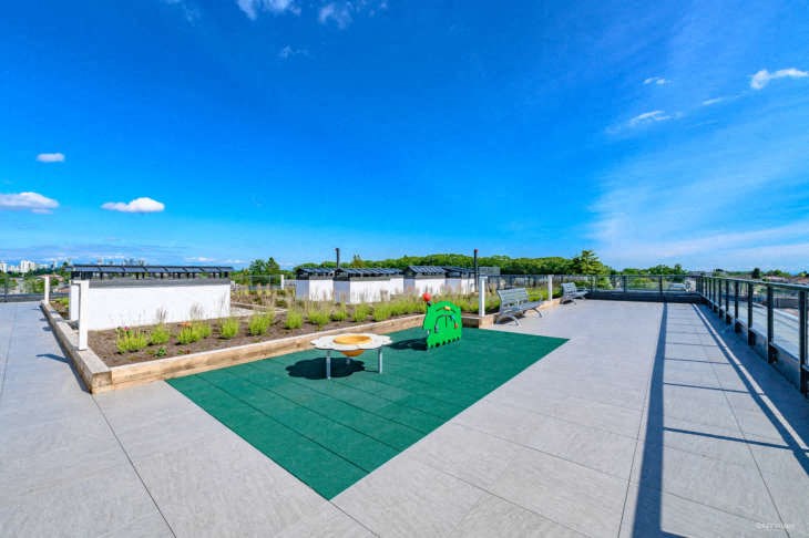 a roof terrace with a table and chairs on it