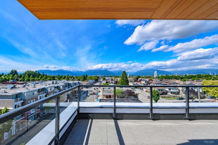 a balcony with a view of the city and the mountains