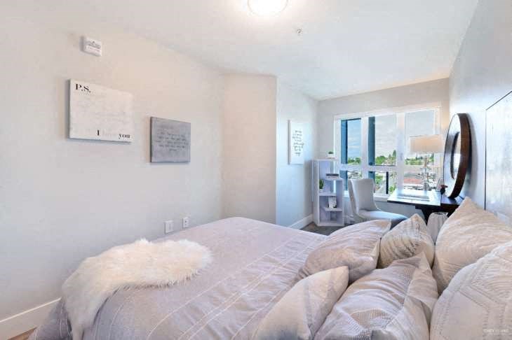 a bedroom with a large bed and a desk