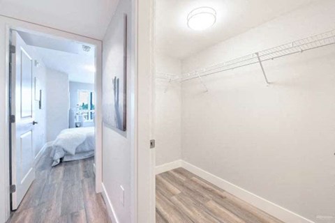a bedroom with a closet and a mirror on the wall