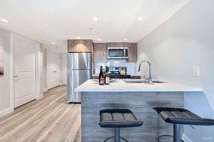 a kitchen with a counter top and a refrigerator