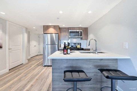 a kitchen with a counter top and a refrigerator