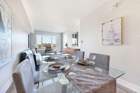 a dining room with a glass table and chairs