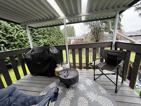 A patio with a black bag and a white jug on it.