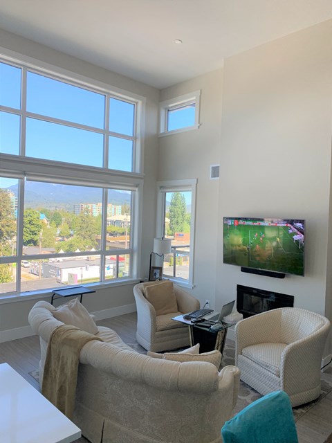 a living room with a couch and chairs and a television