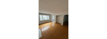 A room with wooden floors and white walls.