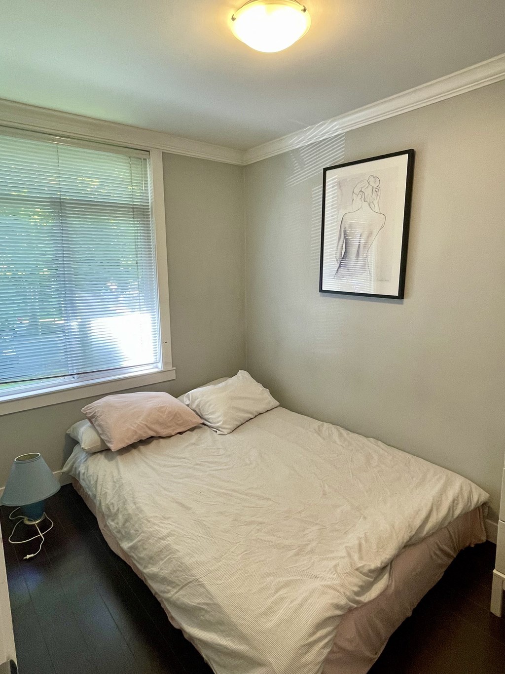 a small bedroom with a bed and a window
