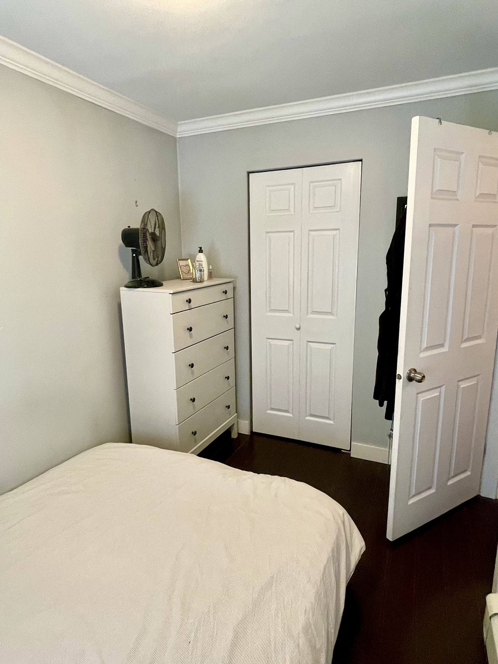 a bedroom with a bed and a dresser