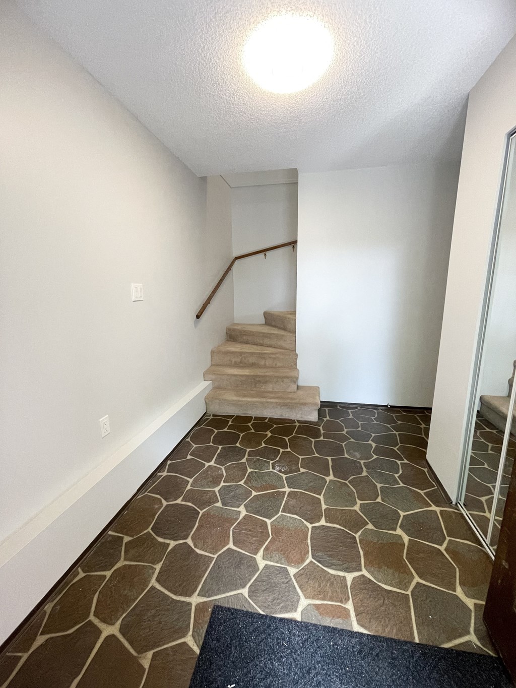 a view of the entryway of a home with stairs and a tiled floor