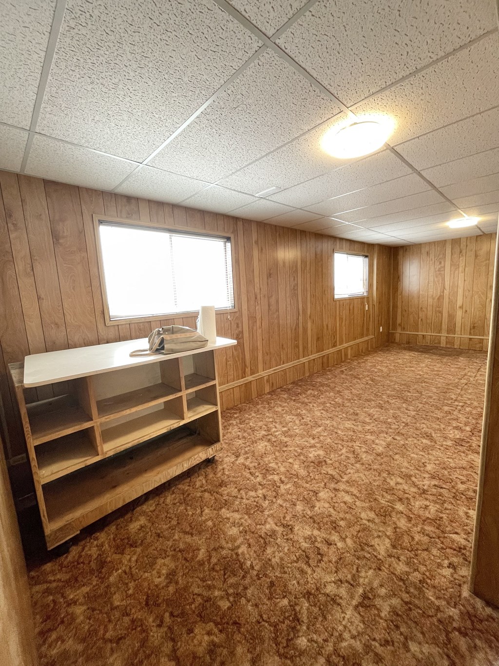 an empty room with a desk and a window