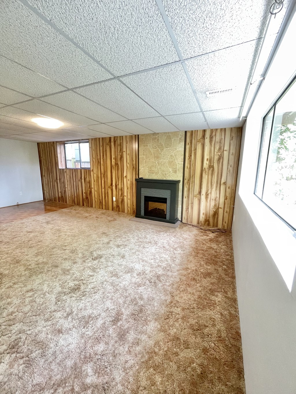 the living room of an empty house with a fireplace