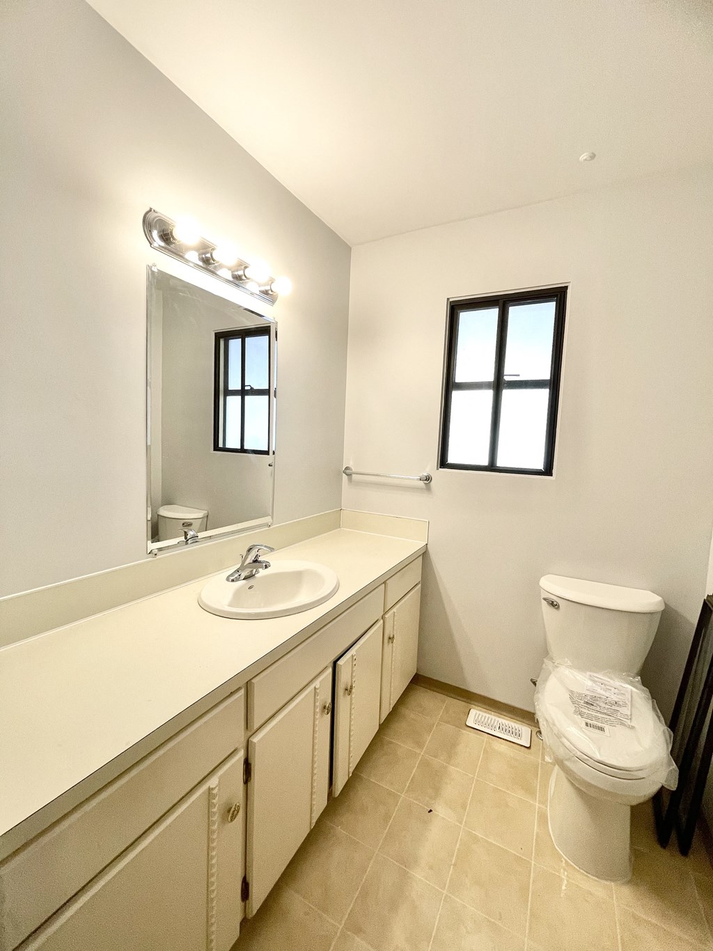 a bathroom with a toilet and a sink and a mirror