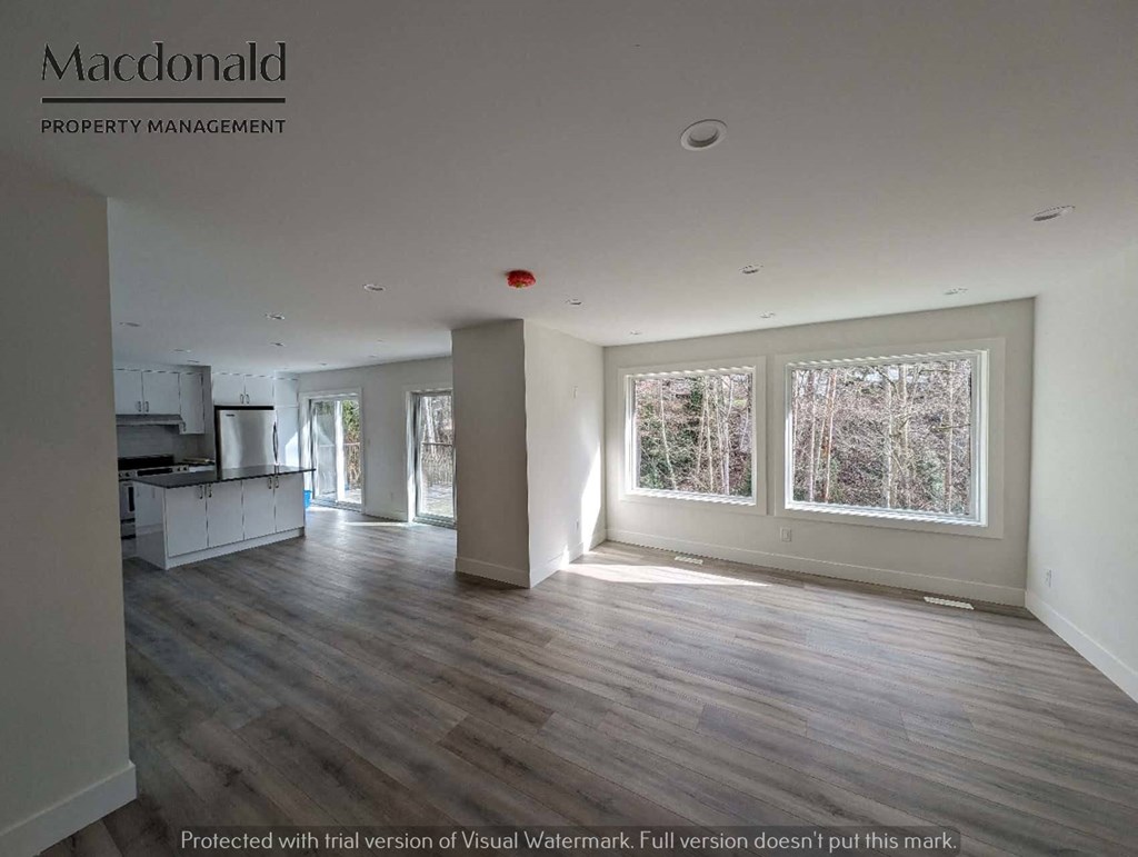an empty living room and kitchen in a new home