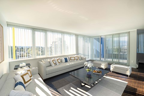 a living room with white couches and a coffee table