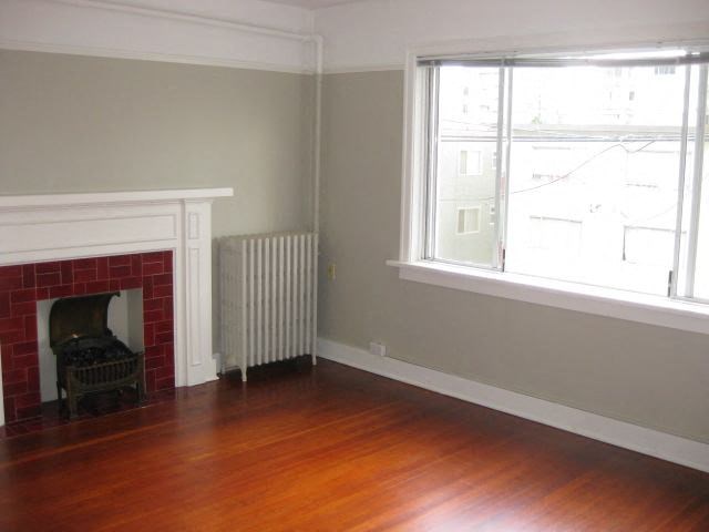 A room with a fireplace and a window.