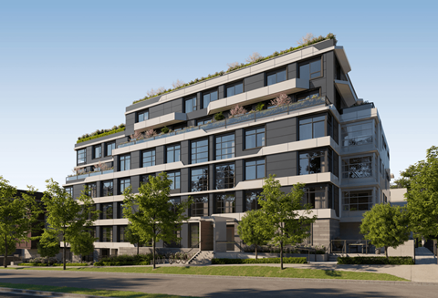 A modern building with a green roof and multiple floors.