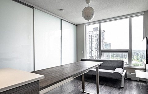 A modern living room with a large table and a couch.