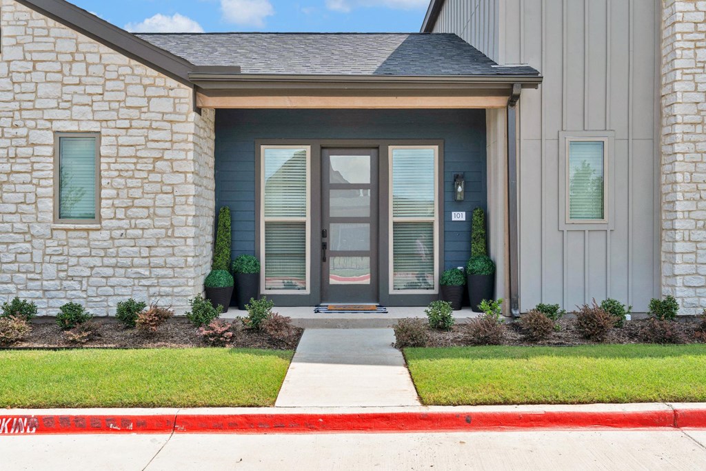 Front of apartment with brick and panel siding