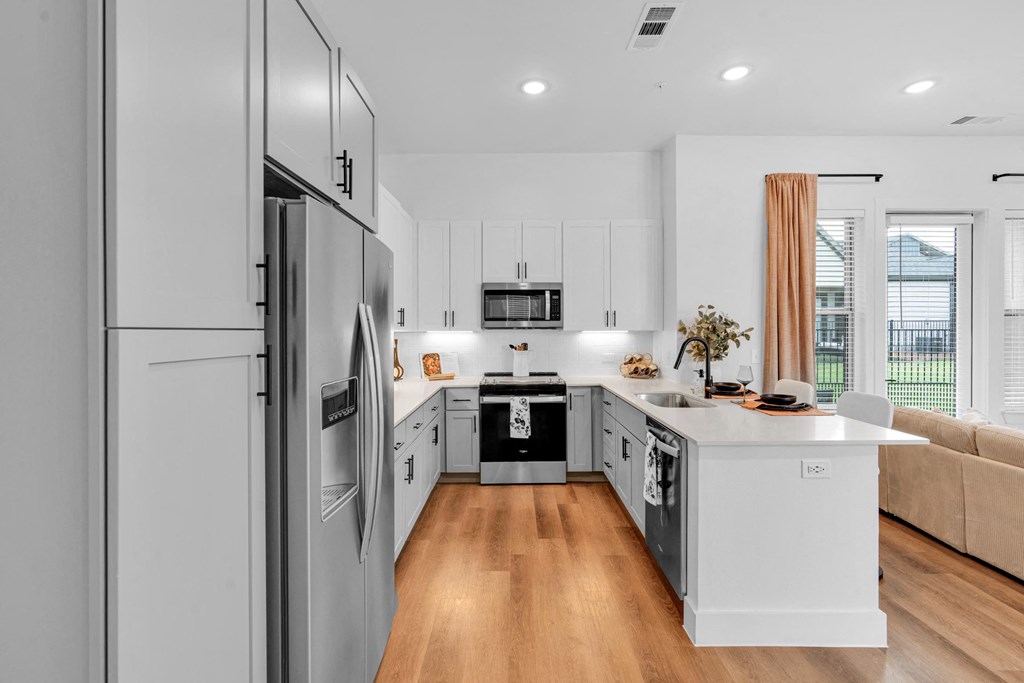 Kitchen with all stainless steel appliances and white cabinets