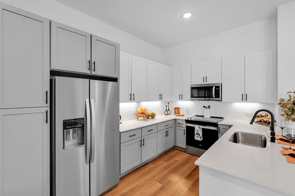 Kitchen with all stainless steel appliances and white cabinets