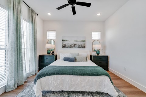 bedroom with queen size bed and ample natural lighting