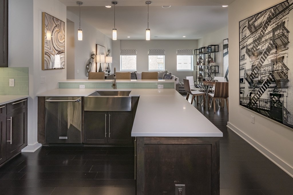 a kitchen with an island and a living room with a dining room