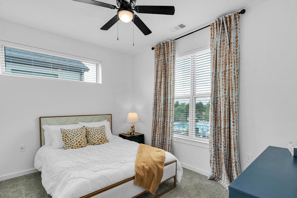 bedroom with queen size bed and ample natural lighting