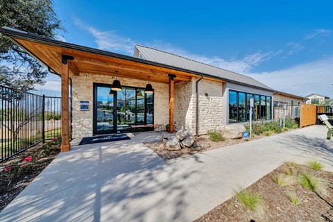 A modern building with a wooden roof and stone walls.