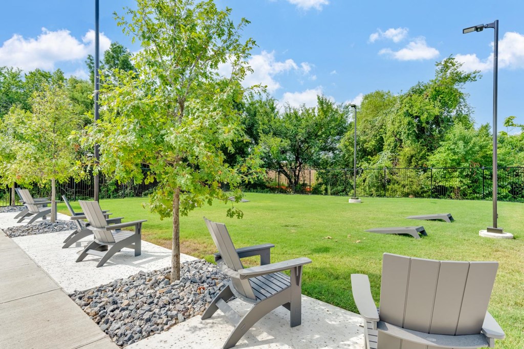 game area outside with green trees and grass