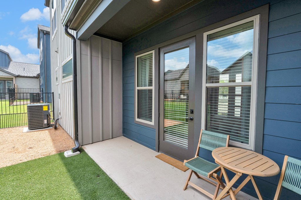 patio with furniture and grassy areas for dogs