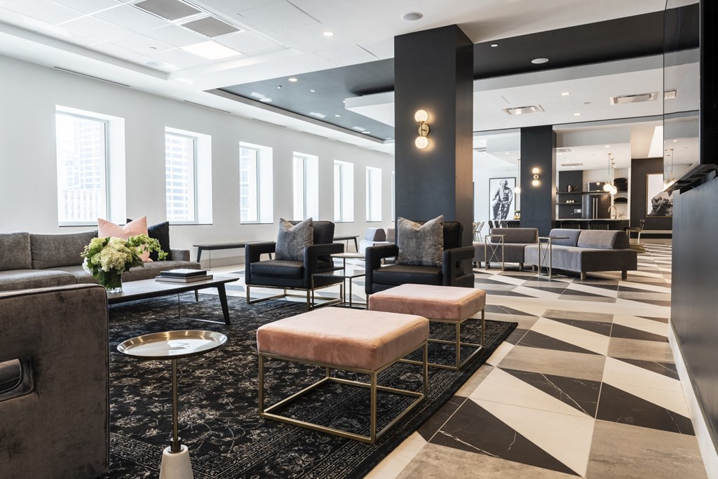 a lobby with couches and chairs and a rug