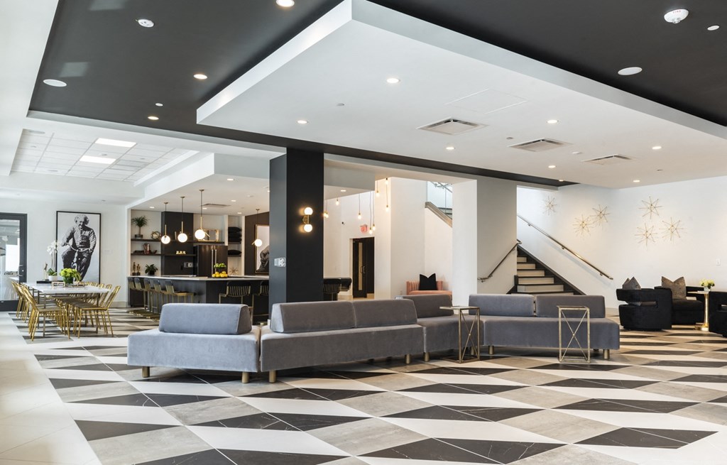 a lobby with couches and tables and a staircase