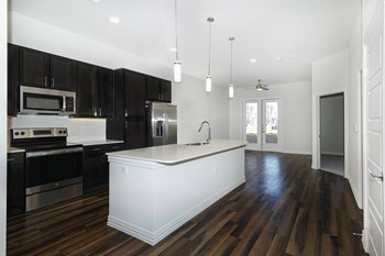 Open kitchen concept Kitchen with hardwood floors and dark
