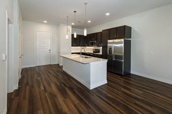 Open kitchen concept Kitchen with hardwood floors and dark