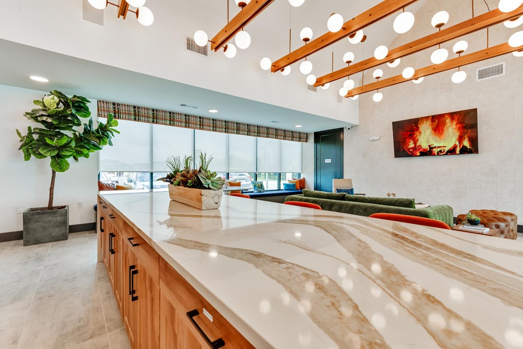 a large kitchen with a fireplace and a large counter top