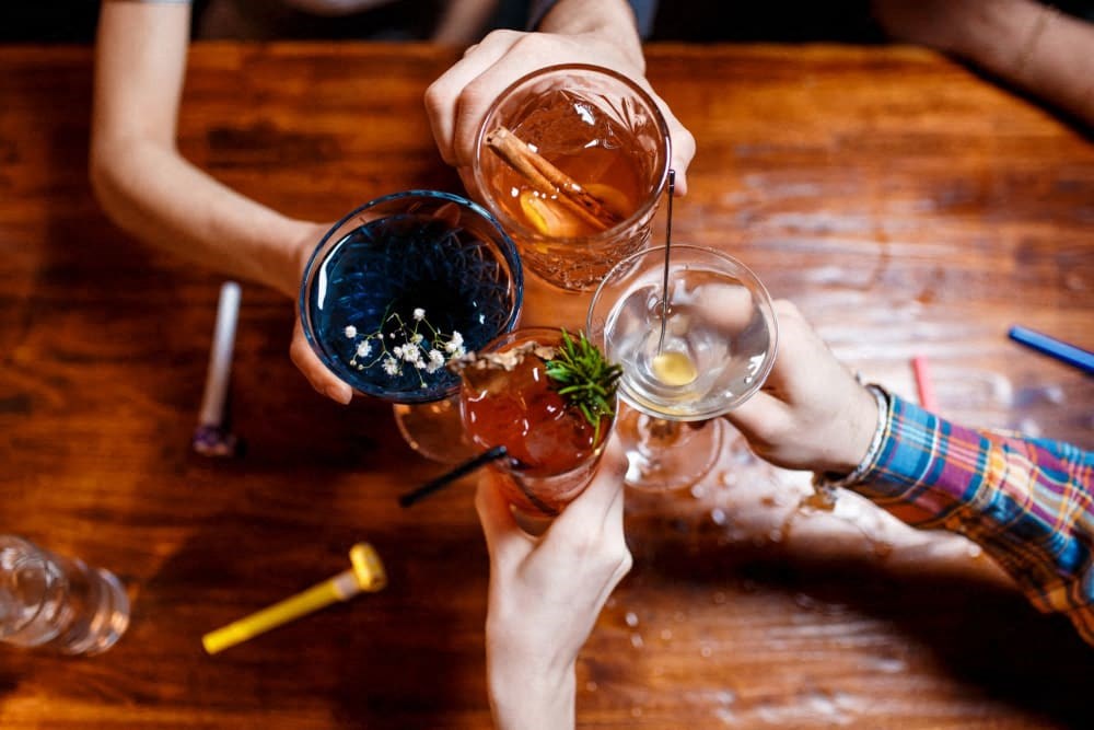 a group of people sitting around a table with drinks
