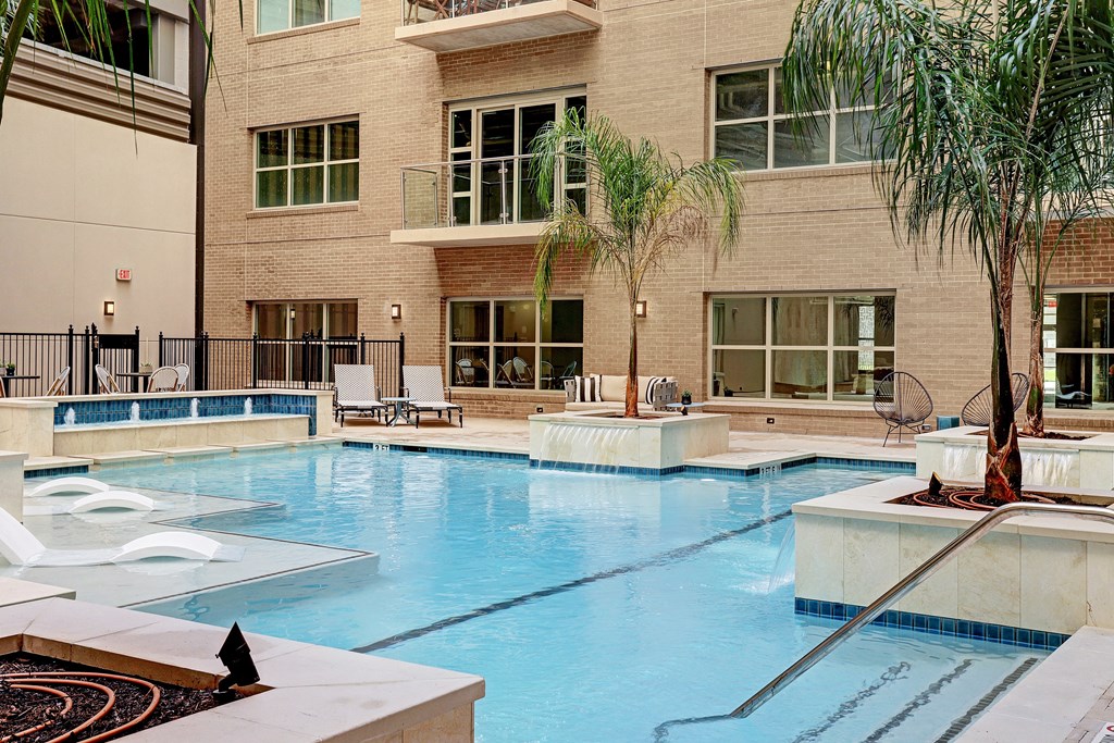 a swimming pool with a building in the background